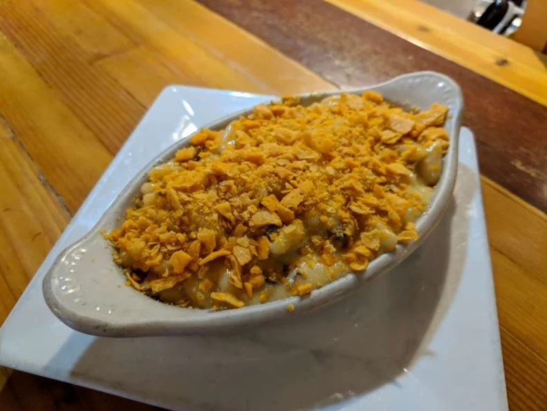 Despite its nickname as Land of the Midnight Sun, Alaska’s long, dark, frigid winters mean that restaurants deliver as much on comfort as they do on flavor. Juneau’s The Rookery Café has an eclectic menu of crave-worthy comfort foods, spanning everything from Korean fried chicken to bacon cheeseburgers, but few can resist the siren call of the mac and cheese. House made cavatelli, whose name translates to “little hollow,” provides ample nooks and crannies for the cheesy sauce, made with nutty Beecher’s flagship cheese and creamy, melty American cheese, to cling to. Instead of breadcrumbs, co-owner and Chef Beau Schooler blankets the noodles and cheese with crushed Cheez-Its crackers for an added sharp Cheddar bite, then bakes the lot in a rarebit dish until toasty. If you’re feeling extra cheesy, double down with an order of the Champagne and Brie fondue.