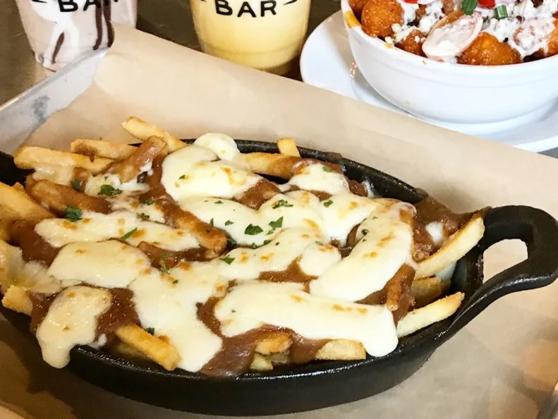 This Portsmouth-based restaurant gained the attention of locals with its gourmet lineup of burgers and milkshakes, but its poutine is what put BRGR Bar on the culinary map. Considered by many to be the unofficial dish of Canada, poutine typically features French fries topped with cheese curds and brown gravy. This traditional Quebecois dish is near and dear to New Englanders’ hearts, particularly those with French-Canadian roots. BRGR Bar lives up to locals’ expectations by honoring the original recipe components — hand-cut fries are piled with Maine’s Pineland Farms cheese curds and drenched in housemade beef gravy bolstered with short rib braising liquid and demi-glace — but takes tradition to the next level by offering unconventional upgrades like short ribs braised in root beer or a sunny-side up egg. For a boozy regional pairing, opt for the Original Milkshake, a bourbon-vanilla shake sweetened with local maple syrup.