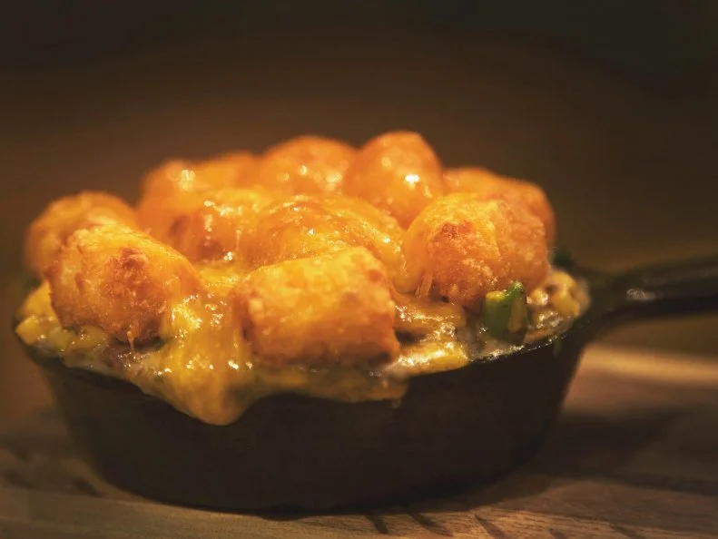 Hot dish is arguably the Upper Midwest’s most nostalgic nosh — a baked casserole made of ground beef, veggies, canned soup and starch (often in the form of tater tots) that’s pretty much a given at church suppers, family reunions, Thanksgiving dinners and basically any regional gathering involving a potluck.  At Bismarck restaurant Humpback Sally’s, tater tot hot dish rounds out a menu of satisfying small plates. It starts off in the standard manner, with a base made of ground beef sauteed with onions, green beans and corn. However, canned soup is switched out for a housemade creamy mushroom sauce bolstered with bacon fat. The mixture is spooned into a small cast iron skillet, layered with crisp tater tots and smoked cheddar cheese, then broiled until the cheese is melted and golden. Though it’s the perfect size for sharing, we won’t blame you for wanting to finish every last bite yourself.