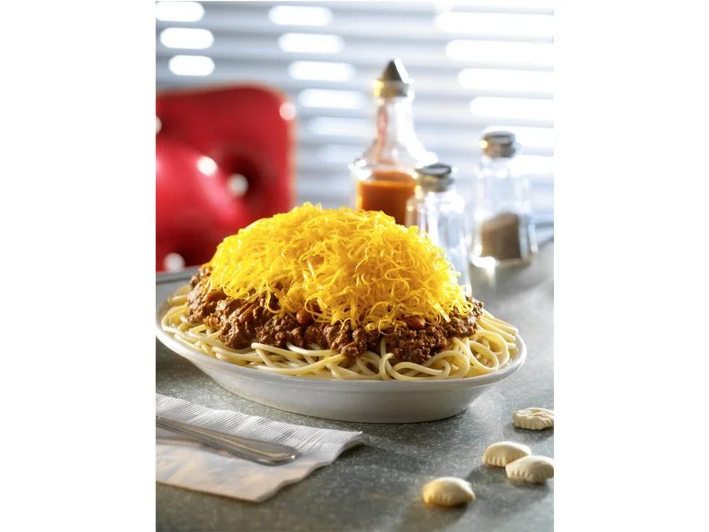 There’s no beans about it — the cheese-smothered chili served at this Ohio fixture is a crowd favorite. Blue Ash Chili has been dishing out classic and modern takes on the signature state dish since 1969. Cincinnati-style chili differs from the average bowl in taste and texture, with a thinner sauce made of meat but not beans, and a blizzard of seasoning that includes cinnamon, nutmeg, allspice and cloves. This Ohio staple dates to the 1920s when Macedonian restaurateurs started offering it as an optional topping for hot dogs, known as Coneys, or on spaghetti. The tradition still exists today, along with the creative system of customization, locally referred to as “ways.” Ask for the Three-Way at Blue Ash Chili and you’ll be served an extra-cheesy spin. The chili is made with fresh ground beef, onions, tomato paste and a secret spice blend, then piled onto a plate of al dente thin spaghetti and mounded with shredded cheddar cheese. Another popular pick is the chili lasagna. To make the dish, multiple layers of flour tortillas are smothered with chili, sour cream and a shredded mound of mild cheddar, then blanketed with more cheese and baked into a cheesy, meaty package of perfection. 