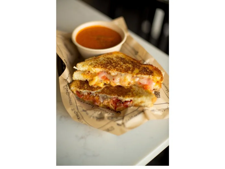 Pimento cheese is a staple of Southern households, where it’s traditionally served with crackers and celery sticks or spread onto sandwiches. This popular cheese-mayo spread has steadily infiltrated restaurant kitchens, too, where it’s being used to boost the richness of macaroni or grilled cheese. Nashville’s The Grilled Cheeserie has changed the game, though, with its Pimento Mac & Cheese: a grilled cheese sandwich stuffed with pimento mac and cheese.  To make the dish, smoked cheddar, mayo and spices are folded with elbow macaroni. The mixture is then piled onto slices of buttered country white bread, topped with slices of Tennessee cheddar, bacon bits from cult local purveyor Benton’s Bacon and thick tomato slices before being finished on the grill.