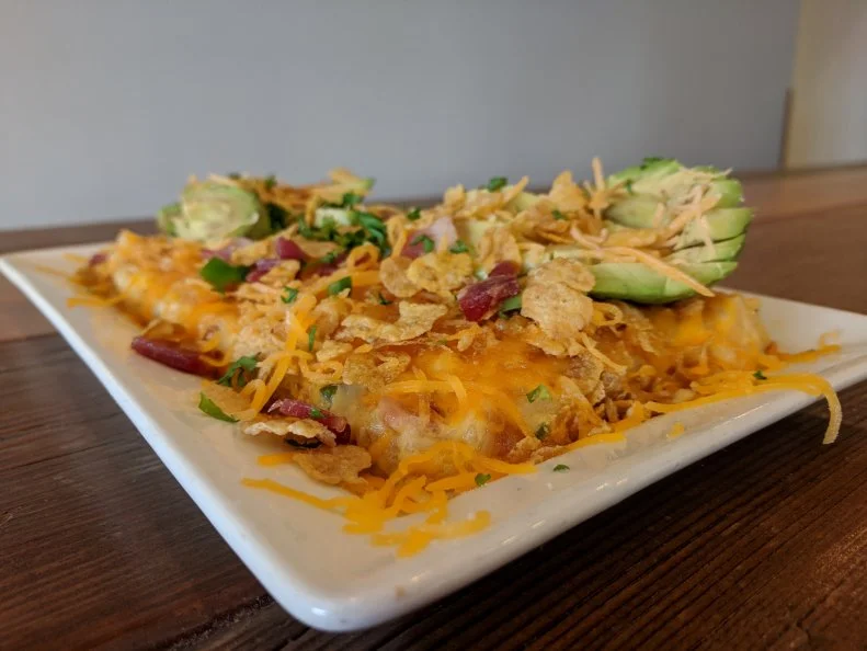 Funeral potatoes — a cheesy potato casserole — are a staple at Mormon gatherings, so named because they were traditionally served as a side dish at funeral dinners and luncheons. Go beyond the basic dish at Wasatch Grind and Pulp, a Utah restaurant with a focus on local ingredients and flavors. The spot riffs on the standard recipe with Angels Landing, a funeral-potatoes-meets-loaded-baked-potato hybrid named after a well-known rock formation in Zion National Park. To start, fresh hash browns are cooked with onions, jalapenos and thick-cut bacon.  Instead of the standard cream of chicken soup, the mixture is combined with a cheese sauce made with sour cream, butter and cheddar cheese, then layered into a dish and baked until the potatoes are crisp. The dish is finished with shredded cheddar, cornflakes (which are traditionally added for crunch) and half an avocado.
