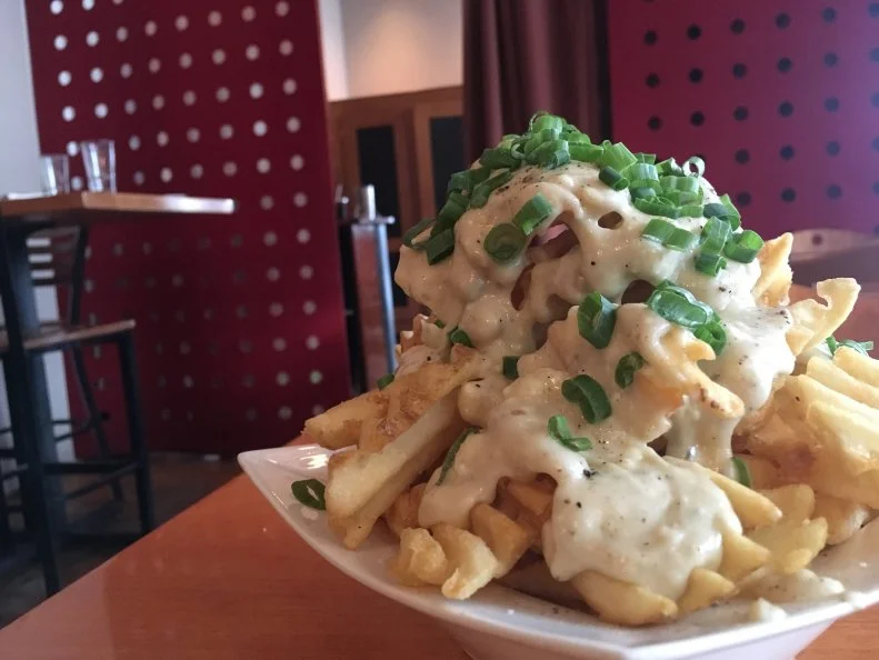 Wyoming may be known as the Cowboy State, but its mountainous terrain also makes it a skier’s paradise. Jackson Hole is home to some of the most famous ski resorts in the country, so it’s no surprise that area restaurants focus on après-ski fare. The Blue Cheese Waffles Fries at Trio bistro are particularly satisfying after a day on the slopes. Crisp-golden fries are heaped onto a plate, then drenched in blue cheese fondue made from a mix of blue cheese and Gorgonzola. A flurry of freshly cracked black pepper and chopped green onions add a burst of color and brightness. The dish makes for a great shared starter, but it’s not uncommon to see solo diners take it on with the same zeal as racing down a black diamond ski run.