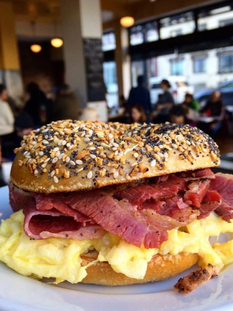 Modern Portland meets old-school Jewish deli at Kenny & Zuke’s. Just like those shops of yesteryear, more than 90% of the menu is made in-house, though most of the dishes feature a contemporary twist. To wit, traditional knishes are livened up with flavorful fillings like herbed yam, chicken pot pie and corned beef and cabbage. While much is new, the place holds true to the old customs. They hand-cut their superb pastrami, which is brined for a week  before getting rubbed down with spices and smoked with oak. The tender meat is best sampled in the Ken’s Special, a sandwich crammed with pastrami, chopped liver, coleslaw and Russian dressing.