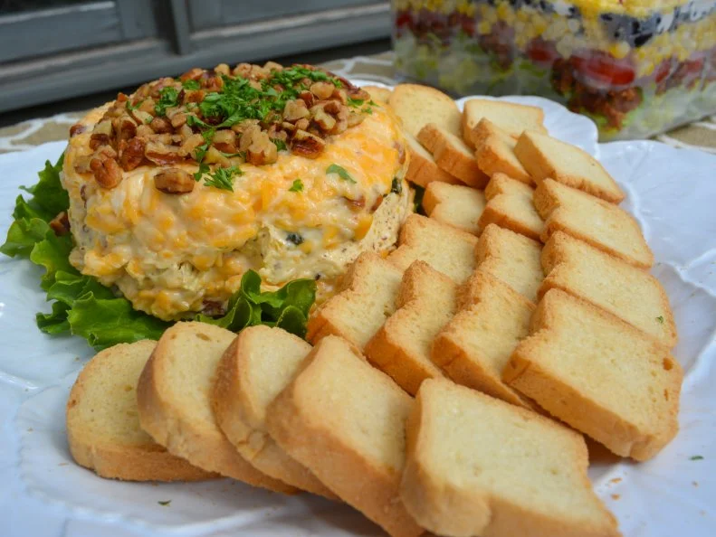 Even folks who detest the combination of fruit with savory foods say The Cheddar Box’s chicken salad with honey and cranberries is weirdly addictive. But that sweet chicken salad (just one of the four available variations) is not the only item that lures the crowds to this Louisville market. Before morphing into a full-scale deli, The Cheddar Box started as a cheese shop in 1979. Those dairy-filled roots are still blatantly apparent in delicacies like gougères stuffed with barbecue almond chicken, tenderloin sandwiches slathered with stilton mayonnaise, and a cheddar pecan torte. 