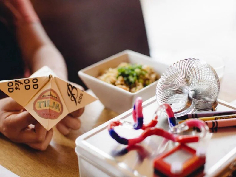 Family-friendly vibes? Check. Quaint neighborhood location? Check. James Beard Foundation Award-nominated chef? Check. When Tilia opened its doors in 2011, chef and co-owner Steven Brown and his business partner, JÃ¶rg Pierach, were both fathers of young children, so it was important that the restaurant delivered both quality scratch-made food and a welcoming atmosphere. That mission rings true today: Kids are welcomed with a â  busy boxâ   filled with sketch books and crayons and fun toys like rubber dinosaurs and finger puppets, and the value-priced kidsâ   menu ($4 for kids under 12) includes favorites like meatloaf made with Wild Acresâ   turkey, and fish and chips made with Canadian northern pike, plus homemade cookies for dessert. Parents can enjoy signature hand-rolled pastas like ricotta cavatelli or cacio e pepe tonnarelli, paired with local brews (look for Pryes Brewing Companyâ  s Miraculum IPA) or a glass of wine from the well-curated list of natural and small-producer wines. Be sure to stop by Wild Rumpus Bookstore a few doors down â   besides an outstanding assortment of kidsâ   books, thereâ  s a menagerie of pets, including ferrets and chickens, walking around.