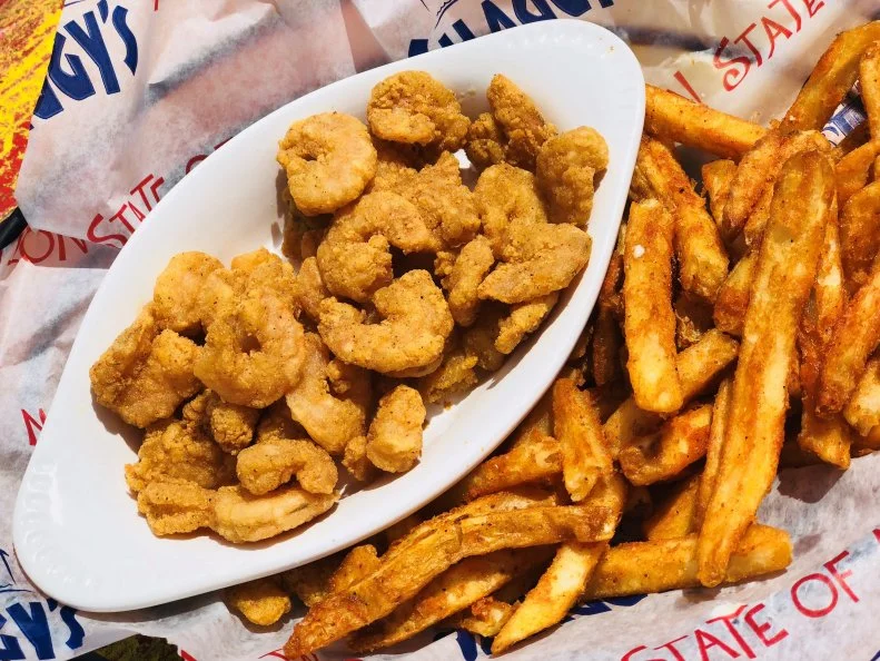 No matter which of Shaggyâ  s three open-air waterfront locations you visit, youâ  ll find the Mississippi Gulf Coast trifecta: food, family and fun. The chalkboard kidsâ   menu includes options like popcorn shrimp and the junior cheeseburger, with sides like French fries, tater tots, veggies, fruit and salads. A supply of chalk is on-hand for little ones to decorate the chalkboard while they wait. Parents canâ  t go wrong with seafood â   the shrimp basket and chargrilled oysters are perennial favorites â   but Shaggyâ  s has also earned a cult following for its namesake cheeseburger. Whatever you order, keep the breezy vacation vibes going with a signature cocktail like Shaggyâ  s Coronarita or a coconut cream pie martini. Thereâ  s also plenty of fun to be had: Each location has a designated kidsâ   play area, like a pirate ship playground, private beach or deck outfitted with games like Giant Jenga, Connect 4 and Corn Hole, and activities like kidsâ   karaoke and face painting. The restaurant also funds The Shaggyâ  s Kids Foundation, which strives to educate children about Gulf Coast marine life.