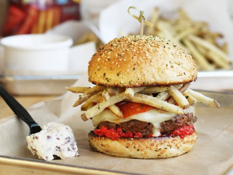 The patty specialists at this Texas-based chain are no strangers to wildly spicy burgers. In 2014, Hopdoddy debuted a fiery ghost-pepper special that was so hot, daredevil diners were required to sign a waiver before eating it. The new limited-edition High Roller may not bring the same level of spice, but it’s certainly no slacker, featuring a taco-seasoned beef patty, pepperoni, mozzarella and Cool Ranch fries sandwiched between two hemp-seed buns. To tie it all together, chefs have created a Flamin’ Hot ketchup that’s as vibrant as the chip itself — and has a spoonful of cookie dough on the side to temper the heat.