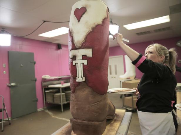 As seen on Food Network's Dallas Cakes, master cake decorater Bronwen Weber adds cocoa powder to the 47-inch tall boot cake to give it that rustic, worn-in look... it also fills the room with the wonderful aroma of chocolate.