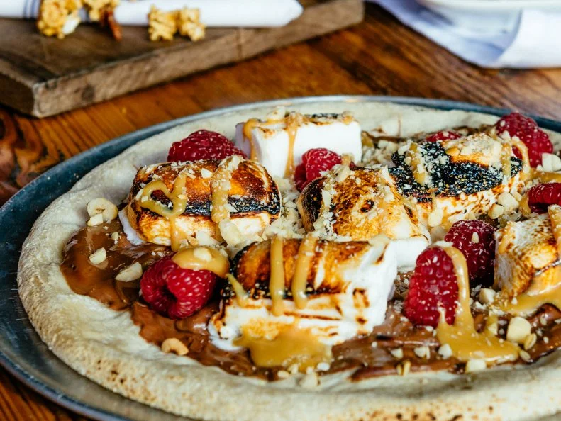 Pizza dough makes an excellent canvas for all sorts of toppings, including sweet ones. In a twist that’s sure to leave diners with a sugar rush, City Winery swaps out the usual savory fixings for dessert staples. Each disc is shellacked in Nutella and dulce de leche, then topped with hazelnuts, raspberries and torched housemade marshmallows. For those who want a wine to pair with the pie, beverage director Jenelle Engleson recommends a glass of the Quinta de la Rosa 10 Year Tawny Port.