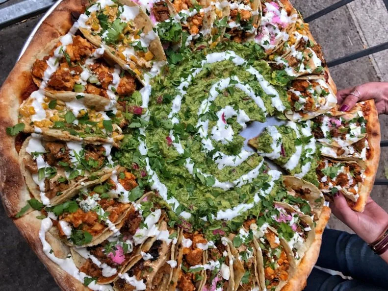 This 30-pound behemoth isn’t just a taco-inspired pizza — it’s literally tacos on top of a pizza. While it has the same foundation as most pies — dough, cheese, meat — the colossal Taco Tuesday special at Tony Boloney's is crowned with 24 soft shell tacos. Loaded with a variety of fillings, they form a ring around a creamy moat of guacamole and sour cream slathered on the pie's surface.