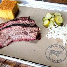 The question of which New York barbecue joint is the best inspires heated debate, but Hometown, in Red Hook, Brooklyn, usually grabs the gold. Ribs, brisket, pulled pork, lamb belly and turkey are smoked in a pit over oak wood and served at a walk-up counter on a first-come, first-served basis until the dayâ  s offerings run out. An added attraction is Hometownâ  s list of craft beers and its wide range of American whiskeys, seasonal cocktails and locally produced wines.
