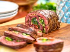 Slicing this rolled flank steak--stuffed with a rainbow of fresh cilantro, tomato and scallion--reveals its inner beauty. Paired with a tangy Thai-inspired rice noodle salad and crisp lettuce leaves, it's perfect for a hot summer day.