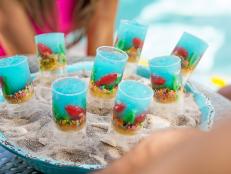 Make a splash at your next summer cookout with these pushable jelly treats filled with gummy fish, licorice seaweed and crunchy candy gravel.