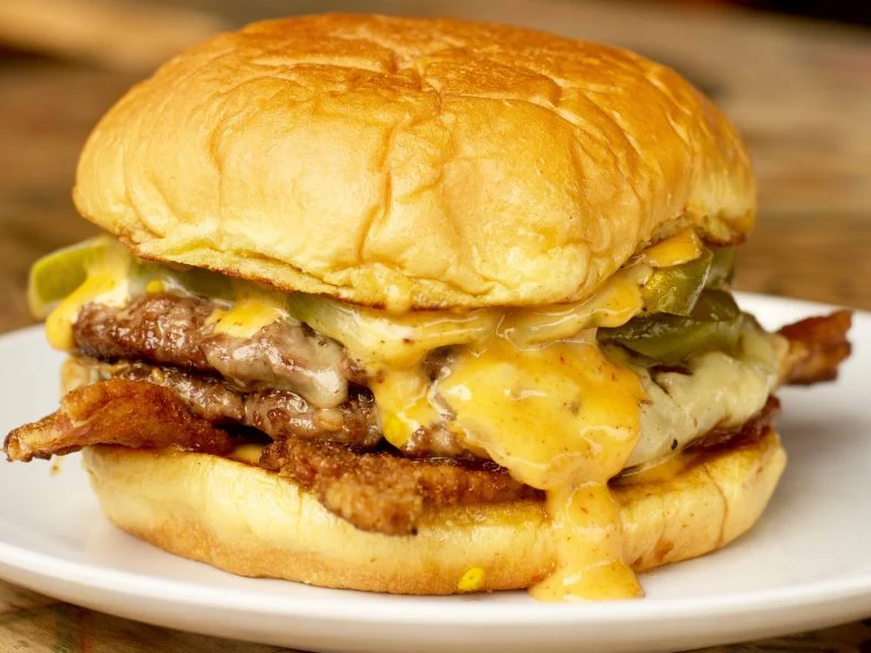 Expect nothing short of old-school awesome at this high school-inspired hang-out where black angus beef patties drip with the juices of tipsy onions braised in Jack Daniels and housemade condiments. Burgers have school-themed names like the Homeroom and the Principal. Getting Detention isn’t a bad thing here, unless you consider a towering double cheeseburger sandwiched between two crispy bacon-grilled cheese sandwich buns a punishment.
www.berniesburgerbus.com