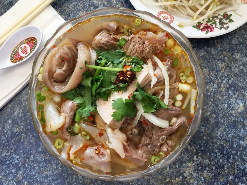 Just a few steps from South Philly’s perpetually crazy Washington Avenue stands Cafe Diem, a no-frills storefront that may not exactly warrant a second glance from hurried passersby. But those in the know hit up this family-owned soup shop for its killer Vietnamese specialties. A standout is the house specialty Bún bò Huế ($9). Built around beef and offal cuts, this lesser-publicized cousin of pho features a punchy broth packed with tongue-tingling chili heat and fish-sauce funk.