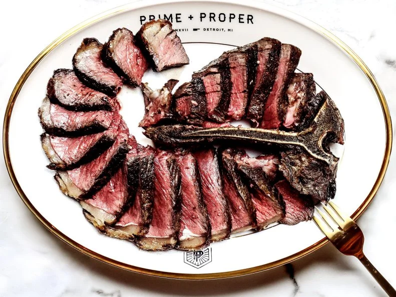 While many of the new Detroit restaurants have erred towards more casual concepts, Prime and Proper exudes full-on luxury. The dining room is a marvel, with a restored marble staircase from the original building, brass fixtures and plush velvet banquettes. Steaks are dry-aged and butchered in house with the modern dry-aging room visible to the dining room through full-length glass windows. Steaks, which include A-5 wagyu cuts, can be served with a torched foie gras with strawberry jam, pistachio, sea salt and Thai basil, and are better with a side of bruleed roasted sweet corn.