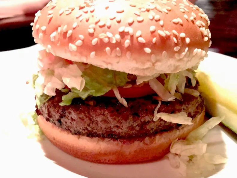 Sometimes the best burgers come in a no-frills atmosphere, like Red Coat Tavern. In tight, dimly lit quarters, youâ  ll find a stellar burger made with a half-pound of the Tavernâ  s proprietary blend of meat. It comes topped with shredded lettuce, juicy tomato and a special sauce, but customers add their choice of additional options, including burnt onions, pico de gallo, ghost pepper cheese and truffle aioli. Onion rings or thinly sliced fries make the perfect side.