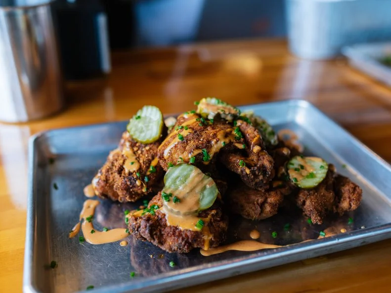 Chef/Owner Bob Brazell has the nickname Bobby Nugz for a reason: his spicy chicken ‘nugz’ are famous citywide. To even call them a nug is an understatement, considering each one is essentially a whole boneless chicken thigh that’s brined, breaded and tossed in Byrd’s spicy, smoky house rub. Five pieces priced at $6 is enough for most people, but if you’ve got a big appetite, splurge for the ten-piece option ($11) — or tack on the spiced tots ($4).