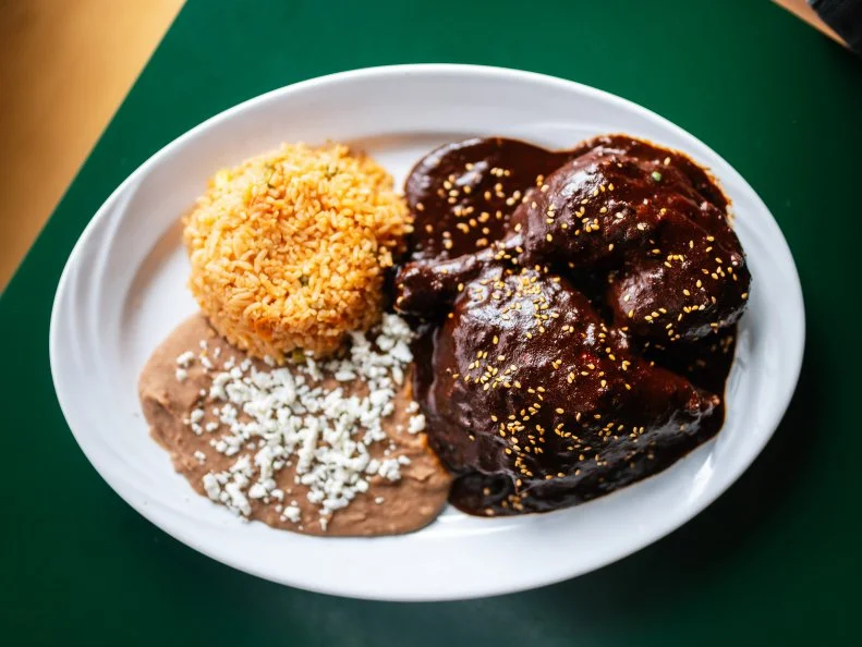 The massive amount of time and sheer quantity of ingredients that go into authentic Oaxacan mole is enough to drive most home cooks mad. Hold on to your sanity and head to La Tejana Taqueria, where you can pick up a masterful chicken mole for $9.99. They roast a quarter chicken, then drench it in their nutty, chocolatey, spicy mole sauce and serve alongside beans and rice. Go ahead and order a side of the mole sauce to dip your chips in… and another container to take home. The splurge is worth it and you’ll likely wind up back in line if you don’t.