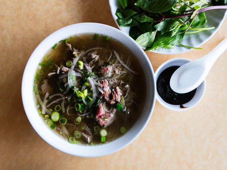 This bastion of Vietnamese cuisine squeezes more than 300 items onto its massive menu, but the pho options are not to be missed. So big are the bowls of Mai Lee’s fragrant soup that they’re practically a ladleful away from being served in a bucket.  The pho tai in particular stands out. Brimming with rare flank steak, rice noodles, herbs, bean sprouts and more, it’s an absolute steal at $8.95. The broth alone is worth it; ginger, star anise and allspice all add depth of flavor to this perfectly balanced base. 