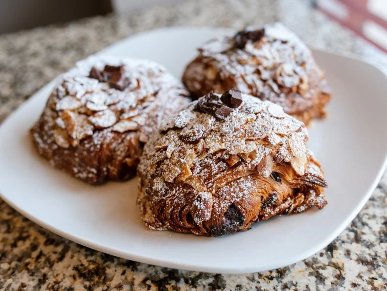 Croissant fans, no longer do you have to pony up the cash for two flaky pastries if you can’t decide between chocolate or almond. Pastry Chef Nathaniel Reid has resolved this classic croissant dilemma by combining the two fillings into one extra-decadent treat. Reid bakes a (perfect) croissant, slices it in half, stuffs it with almond creme, rum syrup and dark chocolate — then bakes it again. Priced at just $3.75, it would be a crime NOT to treat yourself. 
