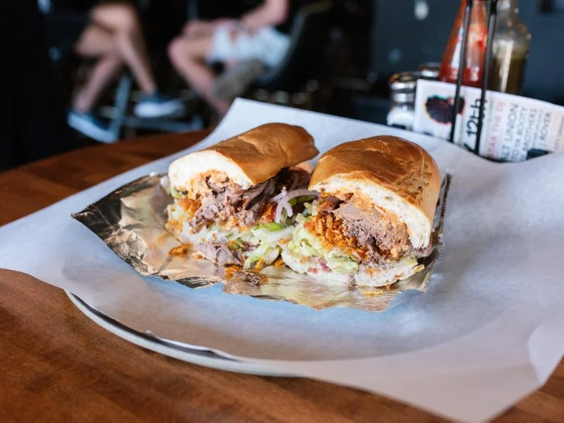 A haven in The Grove neighborhood for night owls craving crazy-big sandwiches to go along with their craft brews, The Gramophone serves food until 2:30 am. Don’t sleep on their signature Mississippi Nights Club sandwich. This beast comes piled with turkey, roast beef, bacon and all the normal sandwich fixings, plus a peppery mayo and an entire bag of spicy chips. If you’re feeling like a sandwich-slaying warrior, get the full size ($11), but if you’re just looking for a large snack, the half ($5.50) will serve you well.