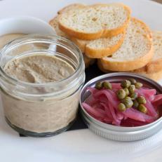 Chicken liver pate served in a cute jar with pickled onions, chives, mustard and bread