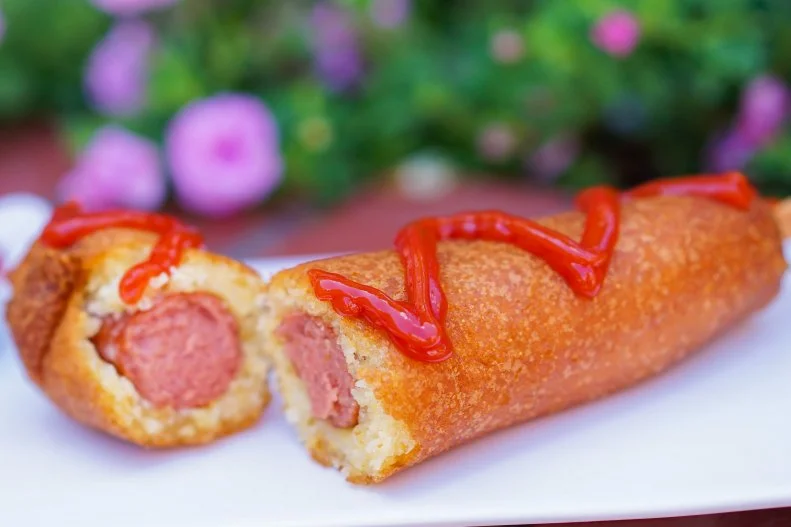 Disney’s corn Dogs are legendary. Little Red Wagon, an old-fashioned bright red vehicle on Disneyland’s Main Street, is the place to try on. Designed to resemble an old-fashioned ice truck, Wagon serves only one menu item, the corn dog, which has drawn long lines for ages. The frankfurters are dipped in batter that is made fresh throughout the day, then fried to order. The result? Breading with a crispy golden brown exterior and a fluffy interior sporting a sweet cornbread-like flavor. At California Adventure, Corn Dog Castle — which has a medieval theme — offers  two alternatives to supplement the original: a spicier “hot link,” and a vegetarian take made with a stick of cheddar cheese, which melts into gooey glory.