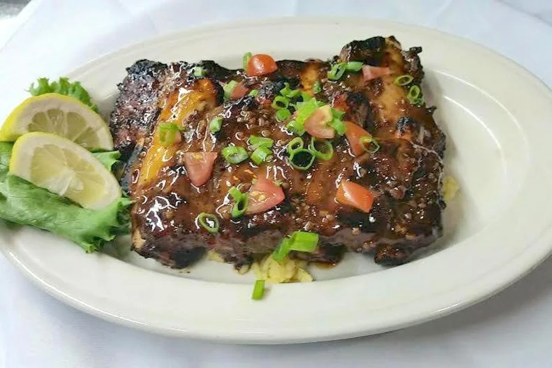 No one can accuse Beef â  N Bottle of chasing the whims of food fashion. Thatâ  s because this iconic steakhouse has been operating steadily since 1958, and it continues to preserve every bit of the mid-century vibe thatâ  s become popular again. Itâ  s more than mere nostalgia. The old-school steak-and seafood menu, along with top-notch service and low-lit decor, combine to create a timeless experience. Weary business travelers and couples on romantic rendezvous alike sink into the simple setting to enjoy a chilled cocktail. Plenty of locals celebrating special occasions return over and over to Beef â  N Bottle for that exceptional filet mignon, NY strip or Delmonico-style rib-eye steak.