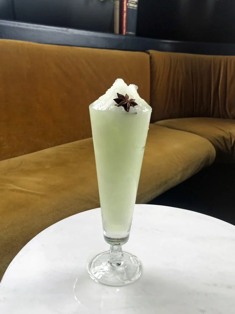 Basically a mint julep kicked up with absinthe in lieu of bourbon, this cocktail lets the Bluebird Cocktail Room, a speakeasy-esque Baltimore craft cocktail bar, offer something fun and refreshing while staying true to its roots. Absinthe, simple syrup and mint extract are blended until smooth, and the light-green concoction is served in a tall glass garnished with a fragrant star anise pod.