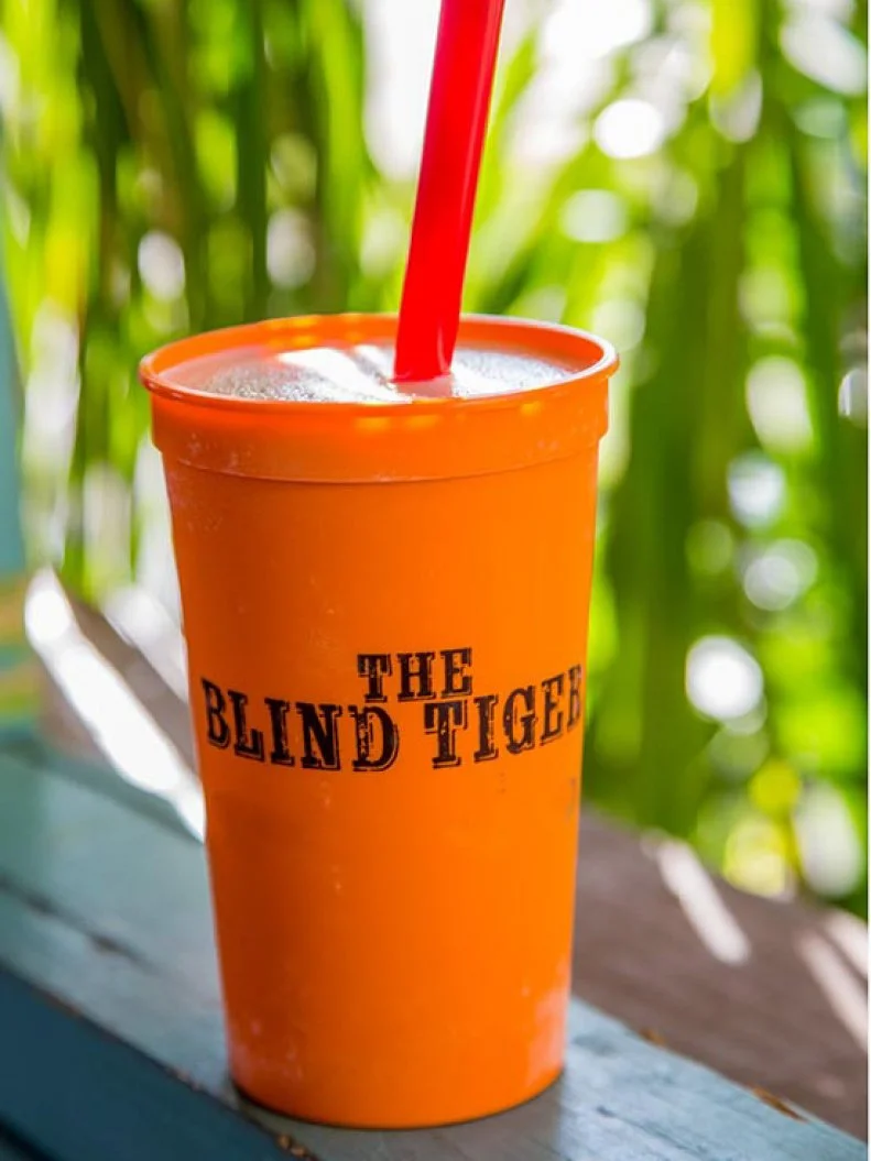 Grab an umbrella-shaded patio table at this brightly painted beachside restaurant on Mississippiâ  s Gulf Coast, and try their version of the coastal classic drink invented in St. Thomas and made popular on Pensacola Beach. Vanilla ice cream is blended with coconut rum, coffee liqueur and overproof rum, served in a souvenir cup and topped with an optional rum floater.