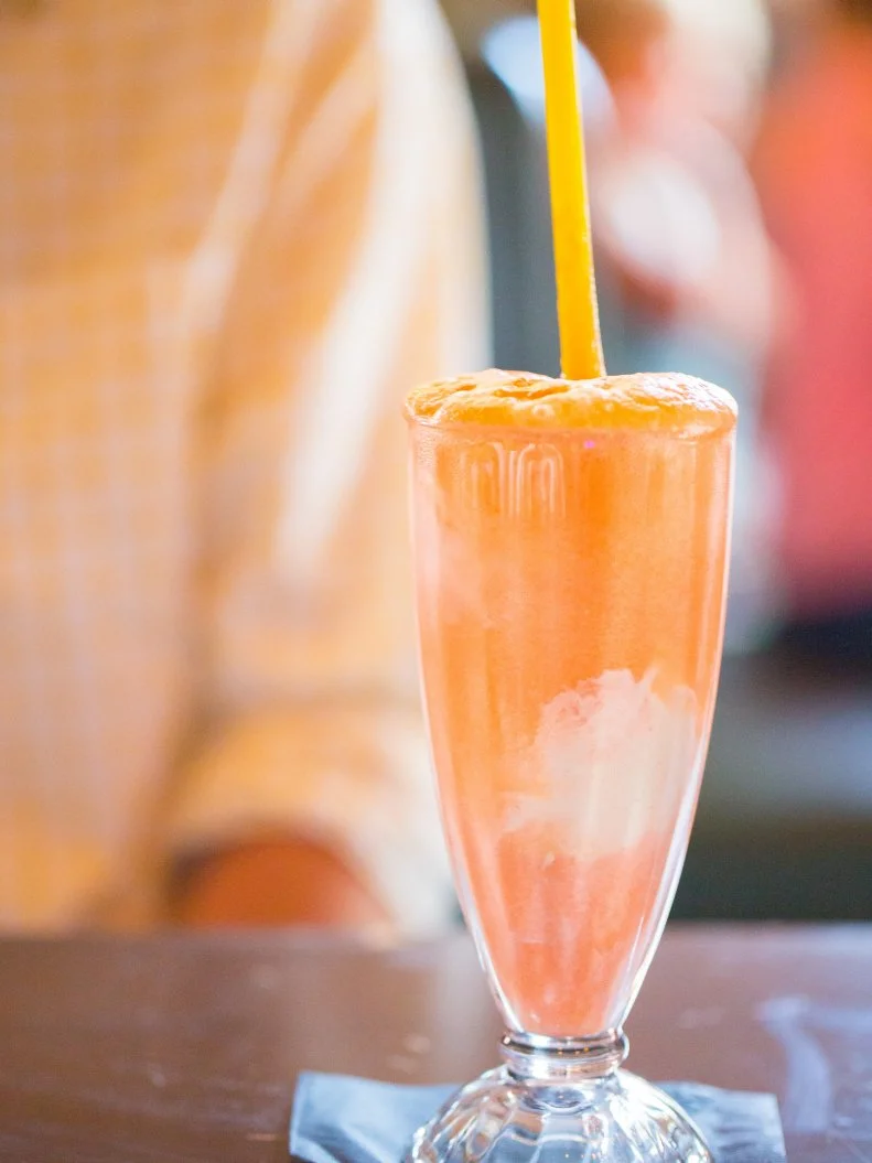 The drinks at this apothecary-themed cocktail den in Cincy are  inspired by the team’s favorite childhood memories and flavors — I Spy, Chutes and Ladders and racy Spin the Bottle, for example. The delightfully decadent, summer-y sweet and low-ABV Monkey in the Middle is named for the kids’ keepaway game. Cointreau, Aperol, elderflower liqueur and orange juice are shaken without ice until frothy, poured over vanilla ice cream and topped with club or cream soda.