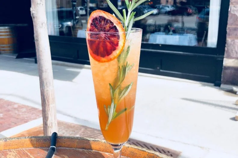 An homage to bartender Paul Squyerâ  s favorite wrestler, Sasha Banks, this drink is equally fierce, cool and bold. He shakes Venezuelan aged rum and blanco vermouth with blood orange-rosemary syrup and lime, pours it into a footed pilsner glass and garnished with a blood orange wheel and a sprig of rosemary.