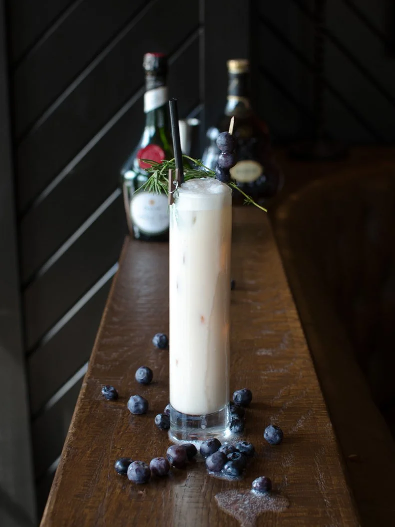 This creamy, dreamy cocktail may look deceptively simple in the glass, but one sip and you can tell it’s about as far from a Pina Colada as you can get. Blueberries are muddled, then shaken with cognac, cream, apple blossom bitters and herbaceous Scotch-based liqueur, all served over crushed ice for a decidedly grown-up boozy shake.