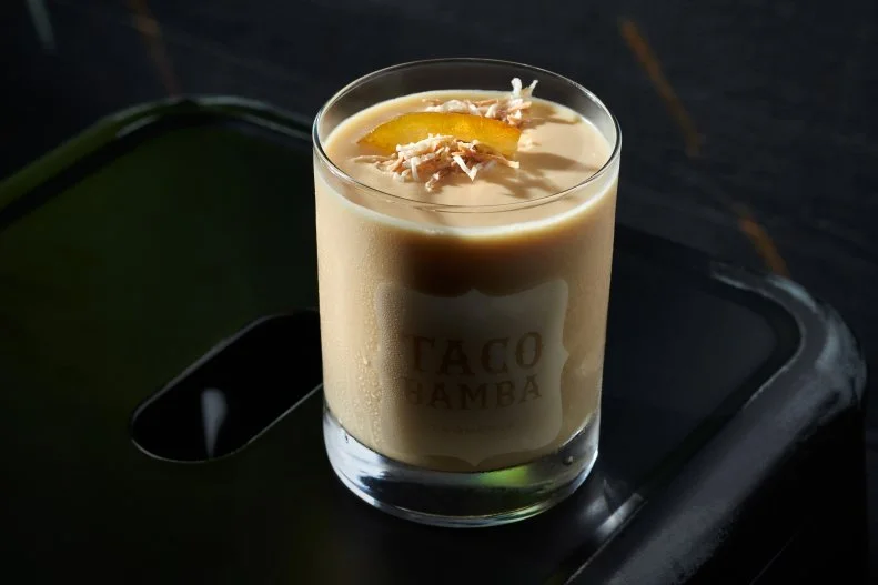 Childhood memories of strolling through the mall in suburban Springfield stirred Chef Victor Albisu to make a version of the frothy orange drink that was once ubiquitous at malls. Tequila, orange juice, coconut cream and lime are blended with ice and served in a rocks glass sprinkled with toasted coconut flakes and garnished with candied orange peel.