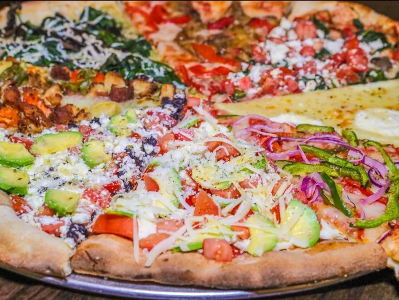 A kaleidoscope of colorfully topped slices beckons from the glass-front case at this beloved slice shop. Long a favorite of university students from the Five College Area, this pizzeria lures the crowds with its multi-page menu of specialty pies sold by the slice. Antonio's features more than a dozen vegetarian combinations alone, with choices that include a classic mozzarella option simply topped with basil and tomatoes, a Florentine slice festooned with spinach and feta cheese, and a quesadilla-inspired creation heaped with avocado slices and nacho chips. The rest of the extensive menu is divided into categories that include meat, pesto, chicken and salad.