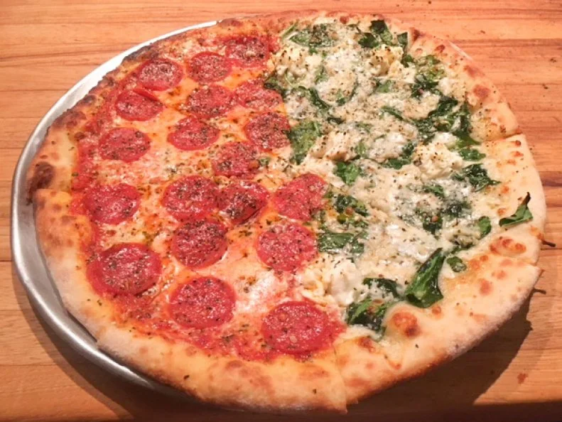 When Danny Dolan and JJ Niebuhr decided to open a restaurant in Honolulu, they knew they wanted to keep it simple. The premise for their place? Pizza and beer in a relaxing, clean environment. They realized their idea with JJ Dolan’s. The place quickly became a neighborhood favorite, serving craft brews and East Coast-style pies inspired by Niebuhr’s Jersey City roots. The menu features classics like Margherita, Jersey white, and spinach and garlic. Combine any two styles in one pie with the half-and-half pizza. Don’t want a whole pie? Stick with the Cheese or Classic Pepperoni, which are available by the slice.