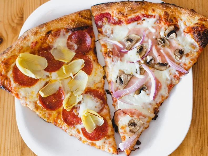For more than two decades, this family-owned restaurant helmed by Otto Hobeheidar has been churning out impeccable pastas and pizzas in a casual setting. Hobeheidar is a Paris native, but he certainly knows his way around a New York-style slice. Every ten minutes, he pulls a fresh pie out of the oven to be used specifically for slices. Made of house-made dough topped with sweet tomato sauce and high-quality mozzarella cheese, his pies are always piping-hot and  glistening with just the right amount of grease. For an extra 59 cents per topping, you can customize your slice with add-ons like spinach, artichokes, feta and meatballs.