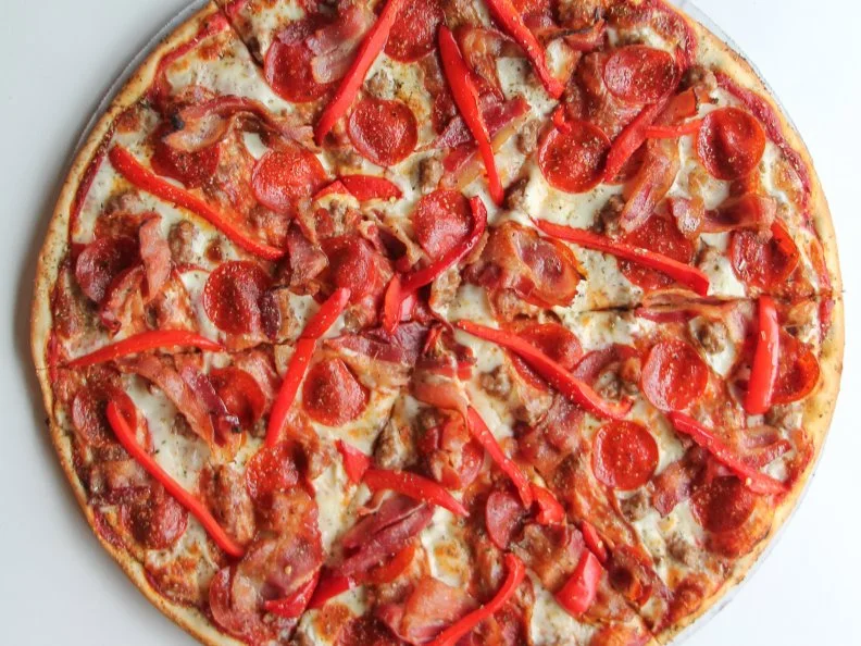 The family behind Pie-Eyed Pizzeria has combined their love of guitar riffs and great slices at this Chicago River West spot. In addition to the band flyers that adorn the space, their musical inspirations are apparent in the selection of thin-crust and deep-dish pizza that pays homage to heavy metal and rock bands. Their Black Sabbath Pizza and Red Hot Chili Pie have both been featured on local news segments. And one of their best-sellers was dedicated to Gwar when the band headlined Riot Fest. This amped-up take on a typical supreme pizza features hot soppressata, applewood-smoked bacon, Italian sausage, pepperoni, red bell peppers and extra sauce. With slices and pies available until 5 a.m. on weekends, it’s the perfect post-concert stop.