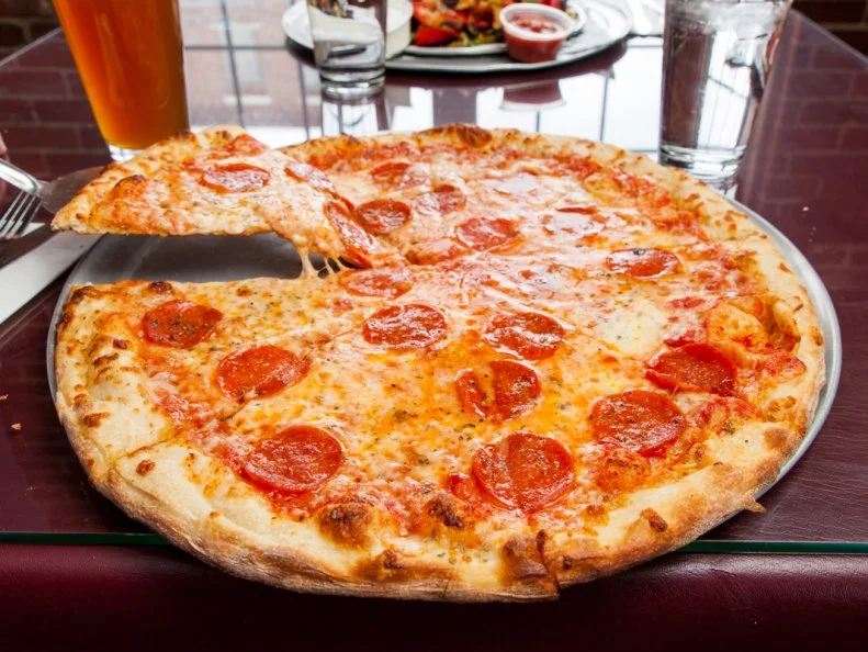 This mini-chain of pizzerias has been steadily spreading the gospel of the New York-style slice throughout the New England region, with locations in Vermont, New Hampshire and Massachusetts. Ramunto’s pies are cooked in a brick oven to give the crust that distinctive crisp bottom and springy bite. Each one is topped with whole-milk mozzarella — no cheddar or fillers in sight. And unlike most other Vermont pizzerias, Ramunto’s offers multiple options by the slice. Pepperoni is the top-selling pick, but those in the know opt for a slice of the signature garlic knot pizza. Creamy mozzarella balances out a bright mix of tomato sauce, minced garlic, fresh sliced tomato and fresh basil leaves ringed by a circle of garlic knots perched along the edge of the crust.
