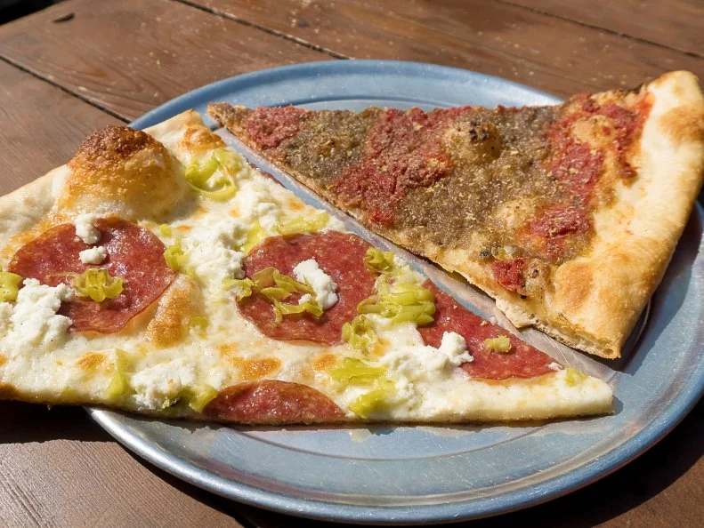 Sizzle Pie was founded in 2011 by two friends from the music and art community who both have a passion for pizza. The place readily embraces all the things the Michael "Mikey" McKennedy and Matt Jacobson have loved since they were kids: rock ‘n’ roll, rad art and that pizza party spirit. With a belief that pizza is for everyone, this East Coast-meets-West Coast pizzeria serves slices and pies in a wide array of vegan, vegetarian and gluten-free options. Popular slices range from the salami, ricotta and pepperoncini-laden Ol’ Dirty to the vegan Spiral Tap with house-made creamy caramelized onion spread, red sauce and cheesy-tasting nutritional yeast. 