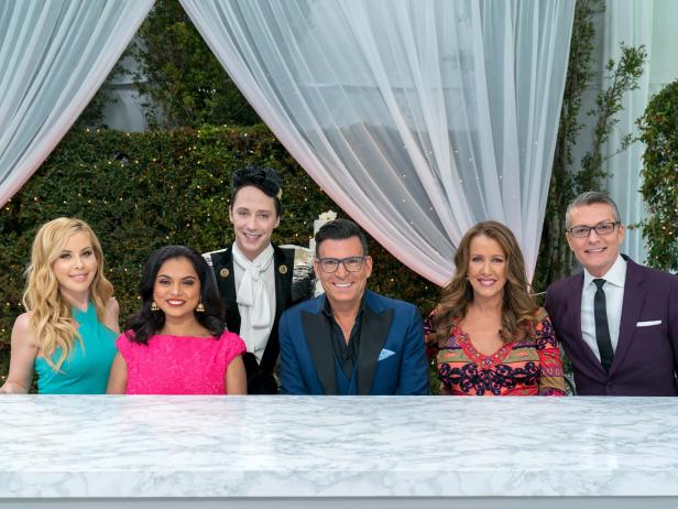 Hosts Tara Lipinski and Johnny Weir with Judges Maneet Chauhan, David Tutera, and Kimberly Bailey and Special guest Randy Fenoli during the judging of the Topper Round, Wedding Dress Topper, Say Yes to the Wedding (Dress) Cake, as seen on Wedding Cake Championship, Season 1.