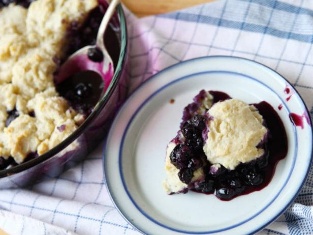 Blueberry grunt scoop on dessert plate.