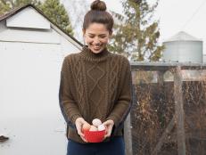 Host Molly Yeh collects eggs from the chicken coop, as seen on Girl Meets Farm, Season 1.