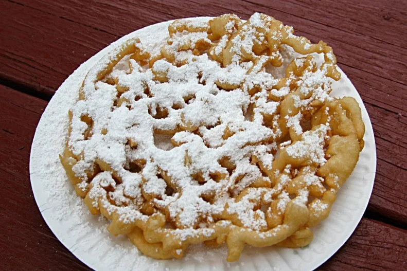 Pennsylvania has more than 100 agricultural fairs, but arguably no treat as iconic as the Pennsylvania Dutch Funnel Cake. Get a taste at The Great Allentown Fair. To make this traditional cake, a batter featuring a blend of flour, milk, eggs, sugar and baking powder is piped through a funnel into hot oil in a circular coil shape; the swirl is fried until golden-crisp, then served hot with a sprinkle of powdered sugar. The funnel cake earned its signature status thanks to a woman named Alice Reinert, who was a regular on the Eastern Pennsylvania fair circuit from the 1960s to the early ’90s. Known for her showmanship, she would narrate in her Pennsylvania Dutch accent while turning out her famous funnel cakes made from a family recipe. 