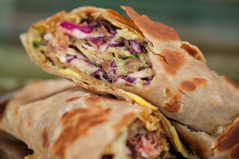 There are dry, cold spinach-tortilla wraps filled with slimy cold cuts, and then there are kati rolls from former Chez Panisse cook Troy MacLarty. At his vegetable-forward, Hindi-cinema–themed Indian street food mecca, they’re made with marinated, seared chicken, fresh paneer cheese, or beef; egg; pickled onion; and a minty chutney, all rolled up in a flakey, ghee-brushed Indian flatbread called paratha ($10.50).