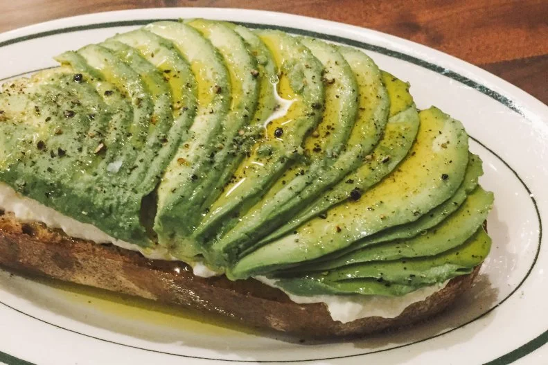 Anyone can smash some avocado on a piece of toast. But at Cup & Bar, they artfully fan out half a whole fruit on a half-inch-thick slice of whole-wheat bread that’s been heaped with house-made lemon ricotta. Then they drizzle the whole thing with olive oil and sprinkle it with lemon zest, salt and pepper ($8.50). Since the café is technically a coffee and chocolate tasting room, consider the toast a fortifying base for all the caffeine and sugar to come.