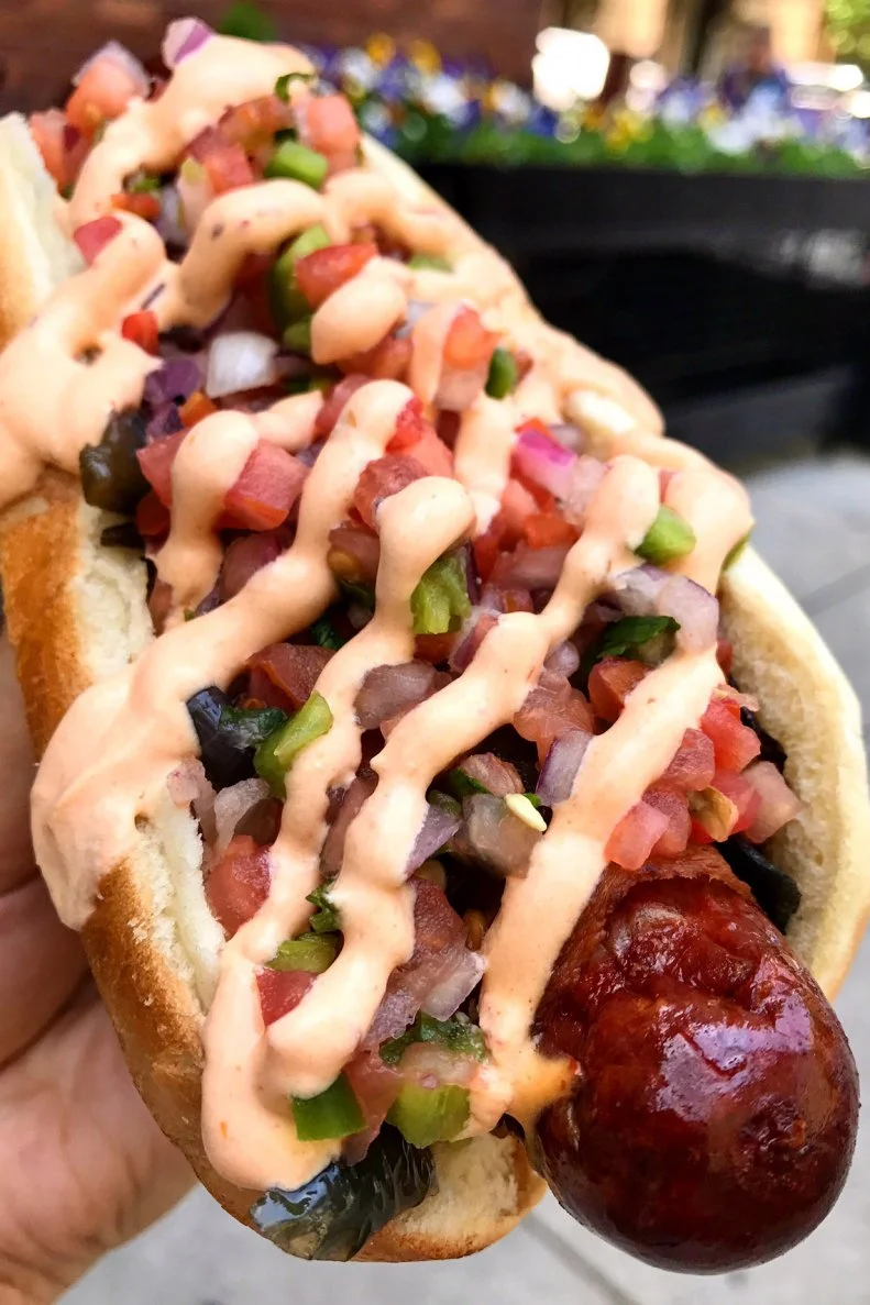 It’s not just the hot wings that draw people to this Chicago mainstay; it’s also Jake’s take on the hot dog. The Jake the Ripper is a spicy hot dog, a local Makowski hot link that’s wrapped in applewood-smoked bacon. It’s topped with pico de gallo, black beans and a chipotle-lime crema before being stuffed into a sausage roll. Be prepared for a mess, or bring out the fork and knife (and a napkin!) — you’ll need them.