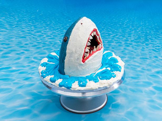 Co-hosts Sunny Anderson, Geoffrey Zakarian, Katie Lee, and Jeff Mauro's dish Shark Cake, as seen on The Kitchen, Season 17.